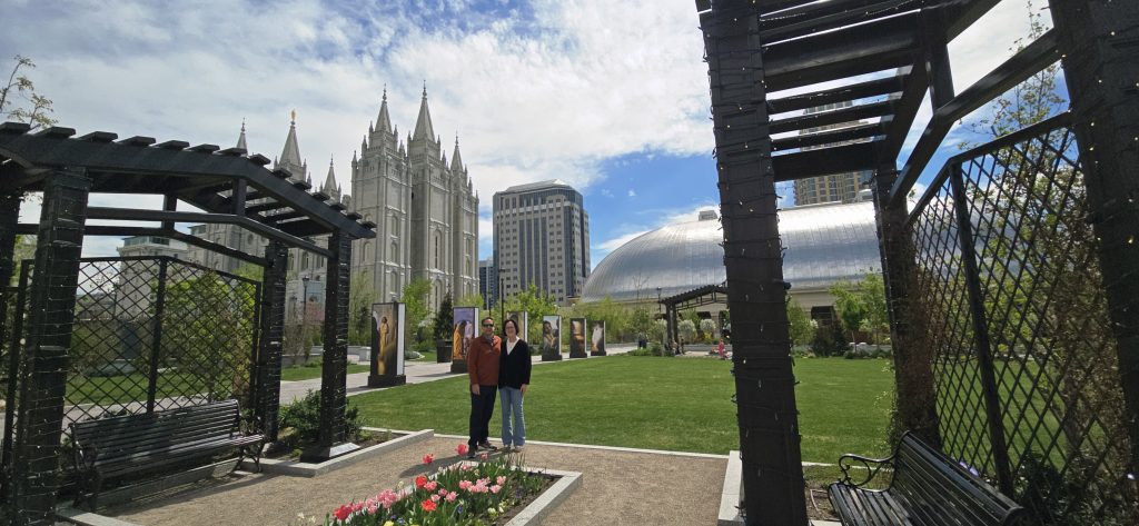 Salt Lake Temple and Conference Center dome in Salt Lake City Temple Square with pergola, tulip garden and couple