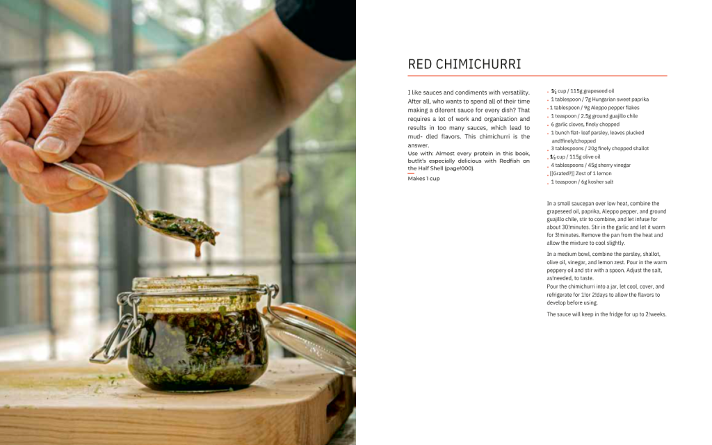 Hand spooning homemade red chimichurri sauce from a glass jar beside chimichurri recipe page