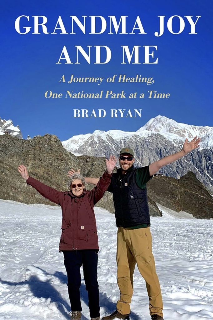 Book cover Grandma Joy and Me by Brad Ryan – grandmother and grandson smiling in snowy national park mountains