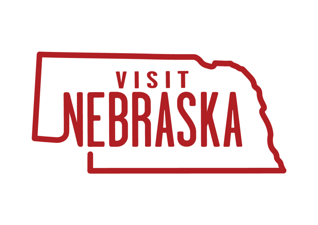 Visit Nebraska logo in red inside Nebraska state outline, travel and tourism branding